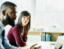 Female Student Listening To Male Student Sitting At Table, Graphic