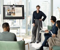 Female Office Worker Presenting To Colleagues On A Surface Hub 2s 50-inch Using Microsoft Teams, Graphic